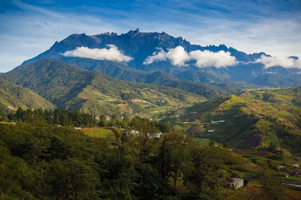Mount Kinabalu above green foothills